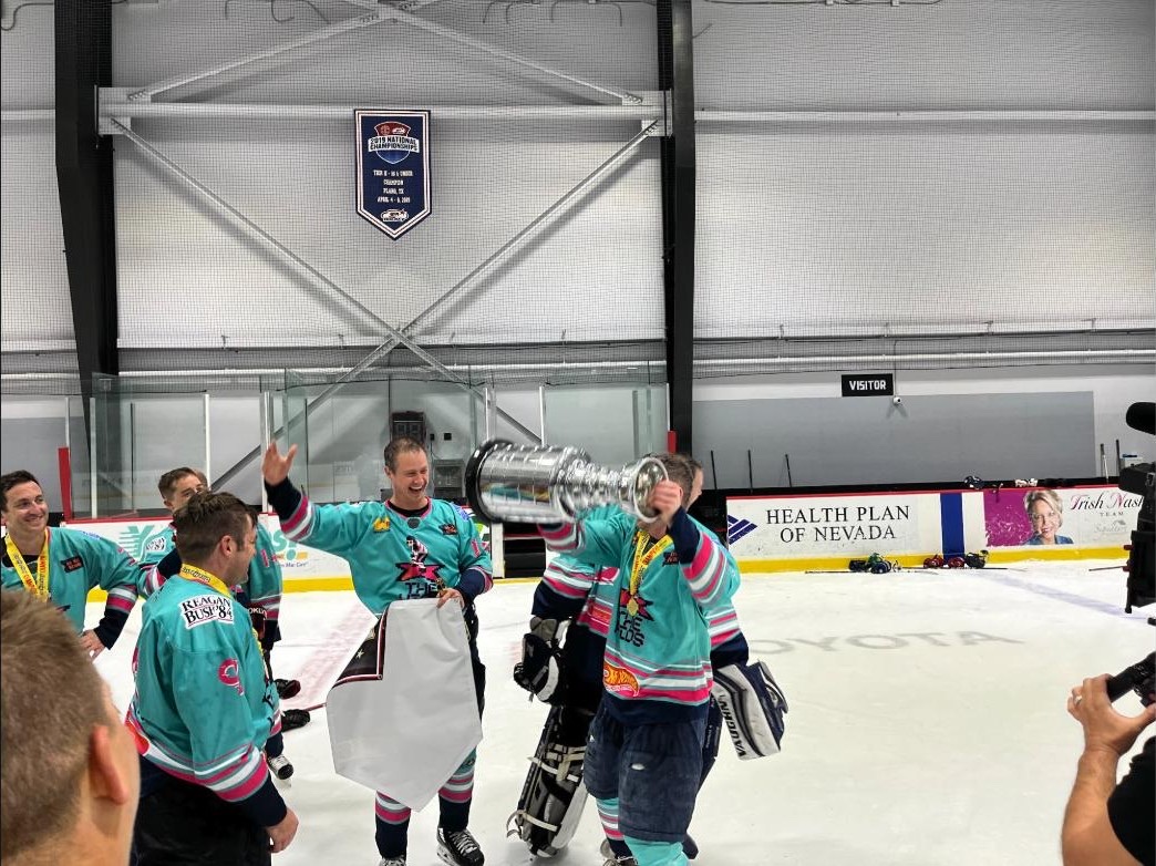 OneHockey adult tournament champions celebrating and lifting the cup on the ice in Las Vegas