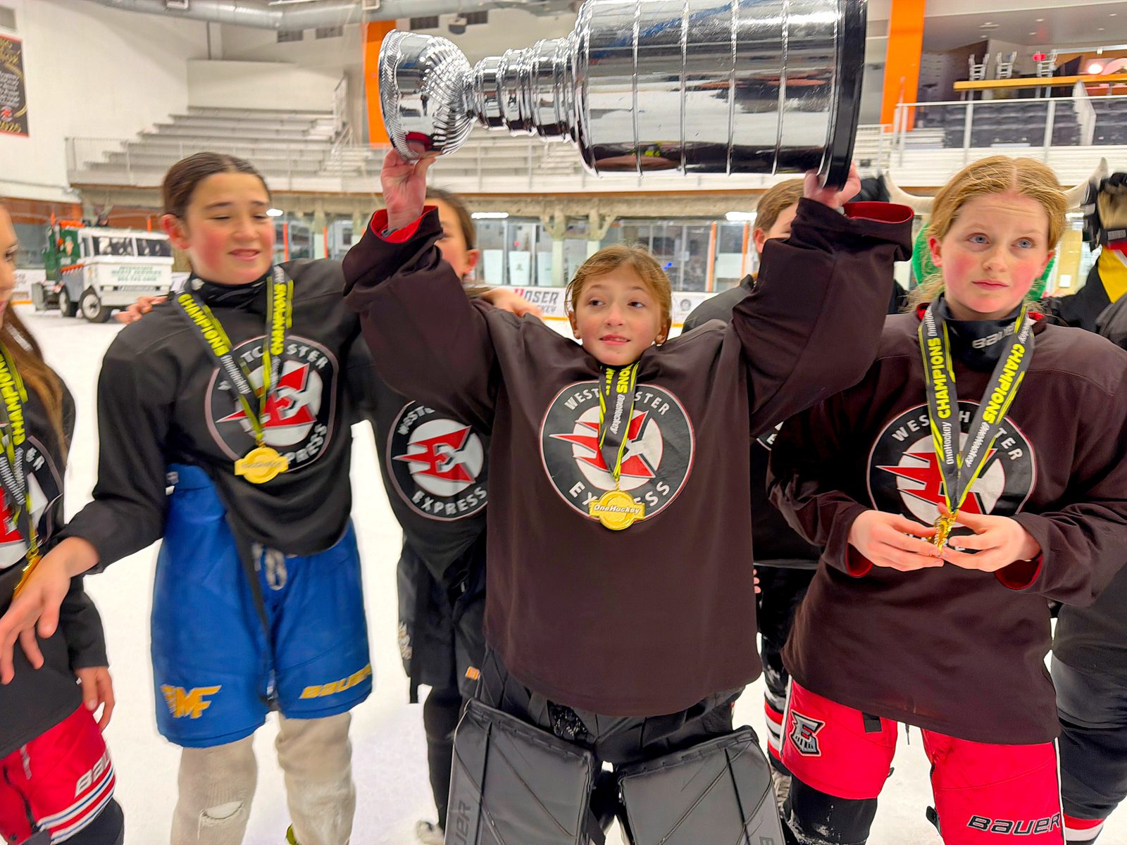 OneHockey youth players celebrating with the cup
