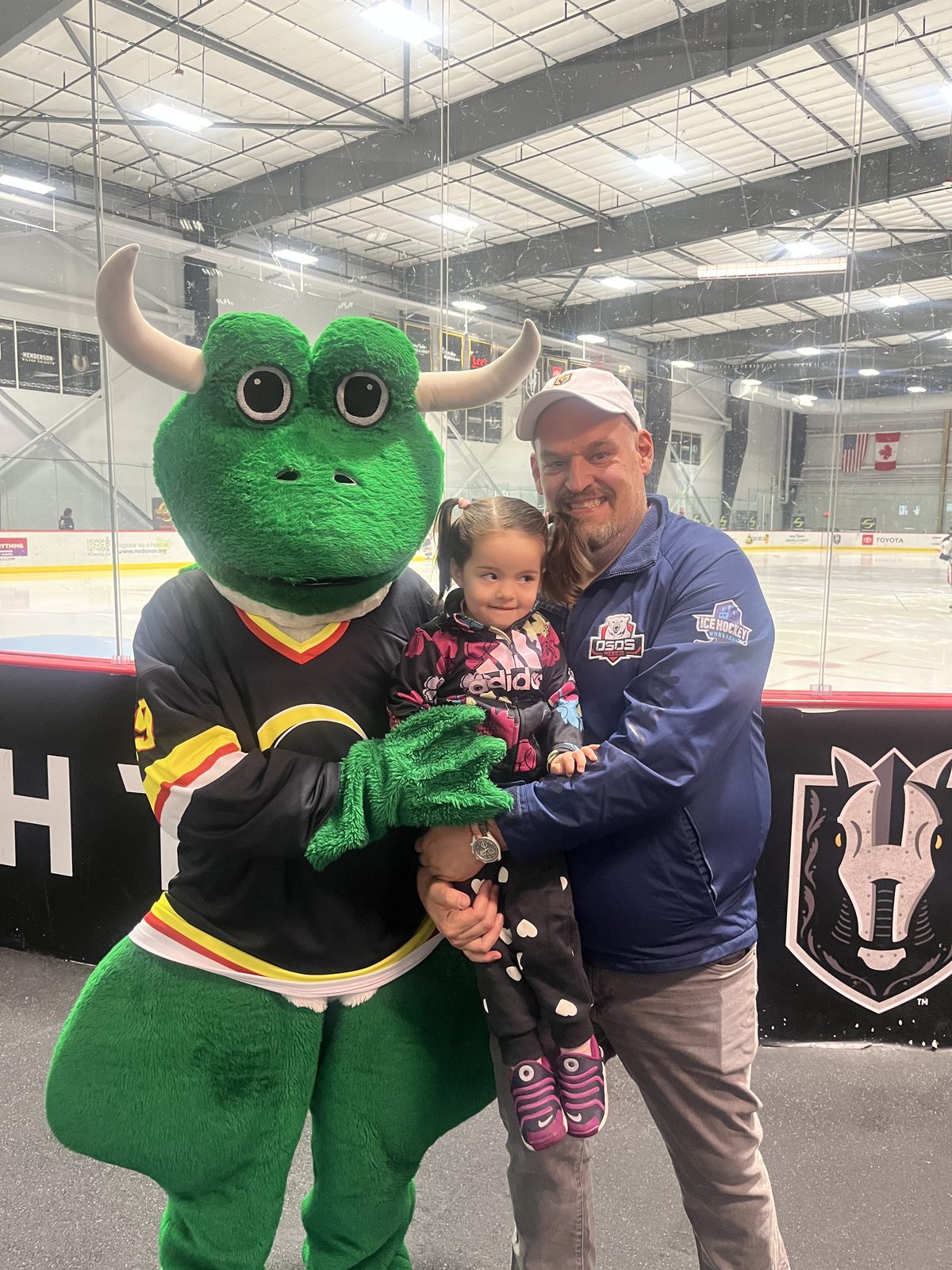 A family with Freddie the OneHockey mascot