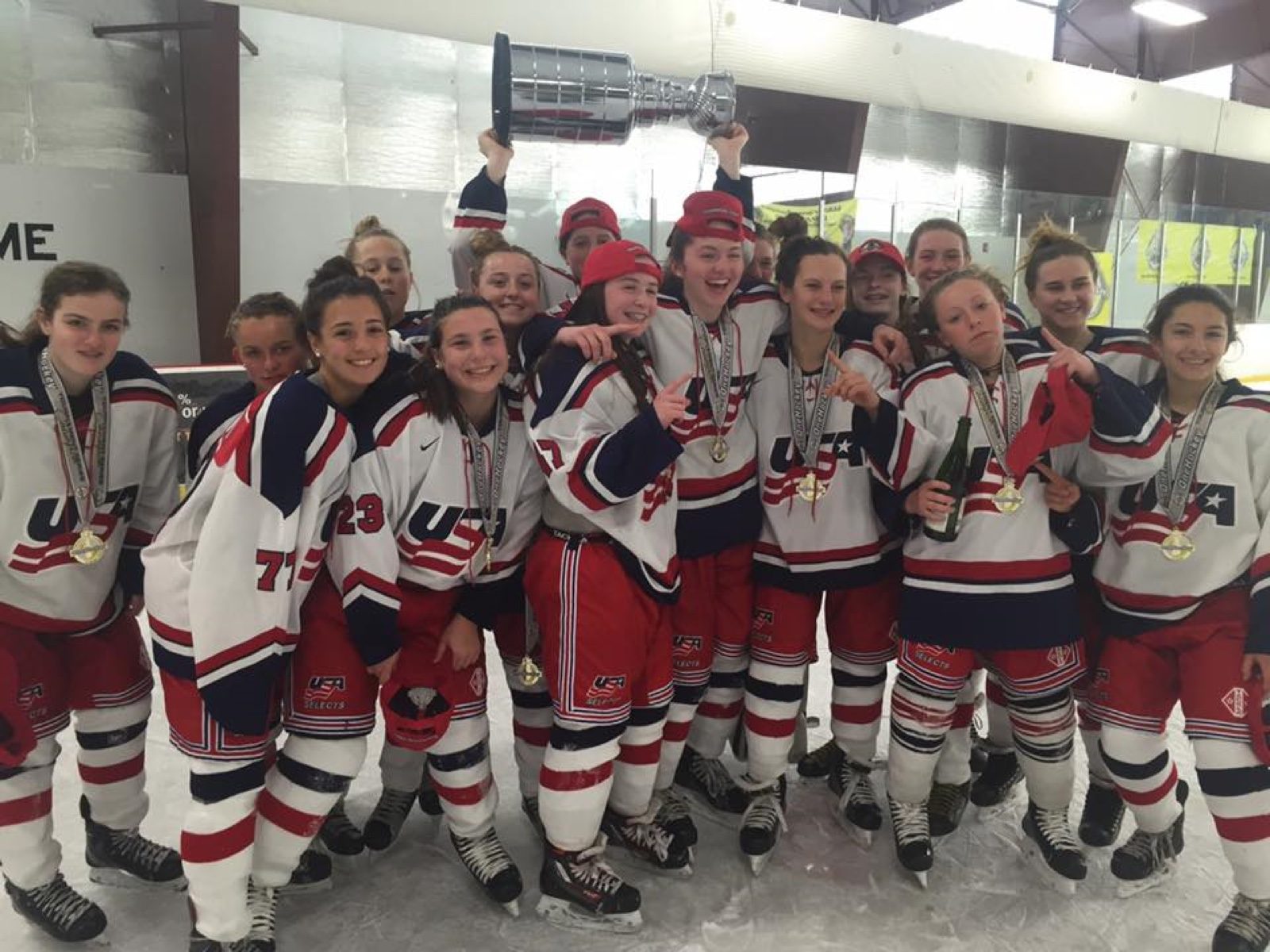 OneHockey youth team celebrating with the trophy